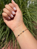 Pulsera ojito negro. Laminado en oro 14k.
