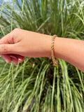 Pulsera estilo torsal. Laminado en oro 14k.