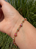 Pulsera ojito corazón rojo. Laminado en oro 14k.