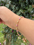Pulsera ojito rosa. Laminado en oro 14k.