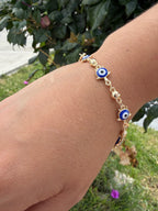 Pulsera ojito tortuga. Laminado en oro 14k.