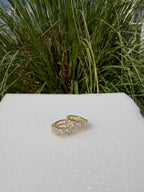 Arete huggie con pedrería. Laminado en oro 14k.